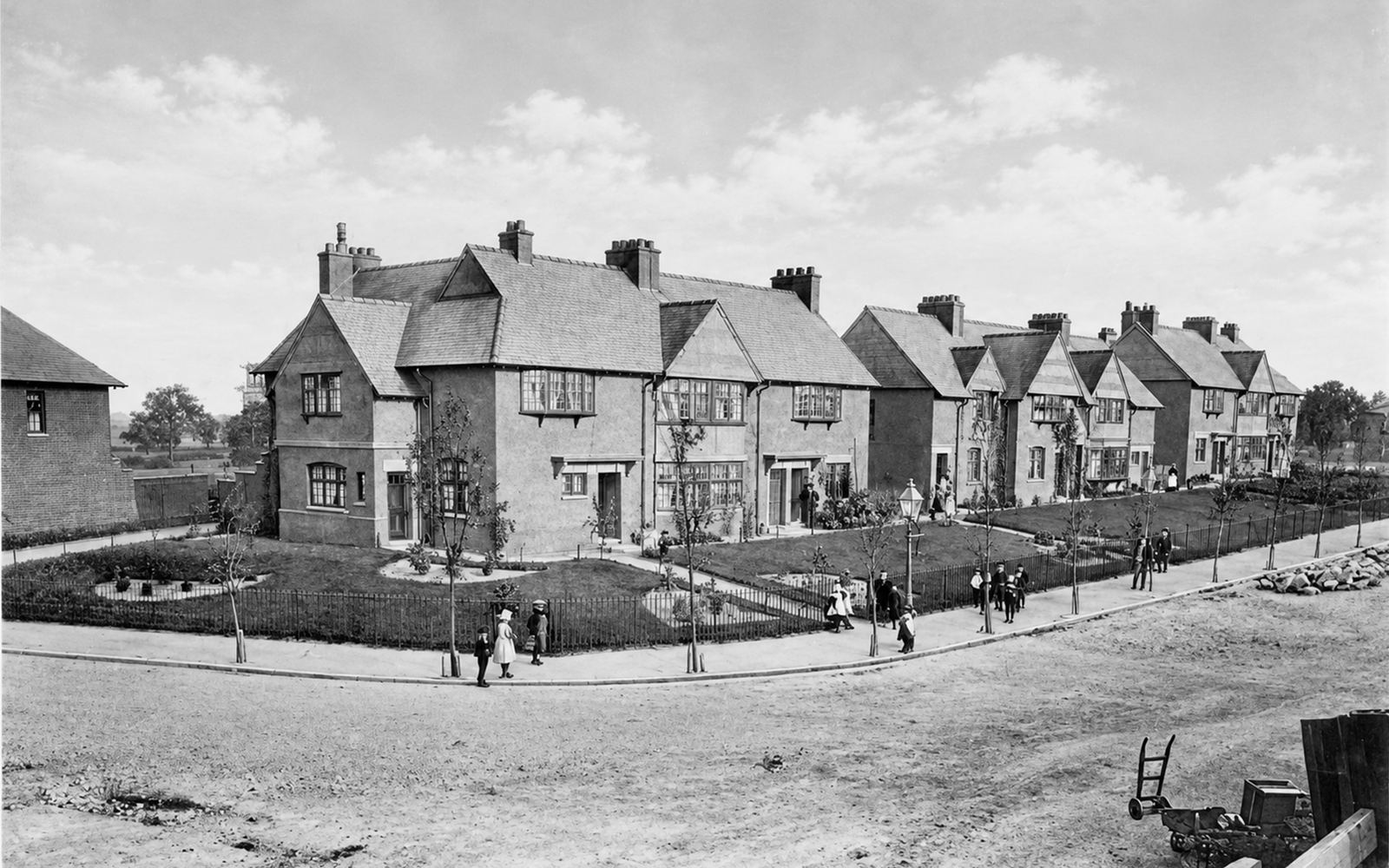 Victorian cottages on a village street corner, with children on the pavement